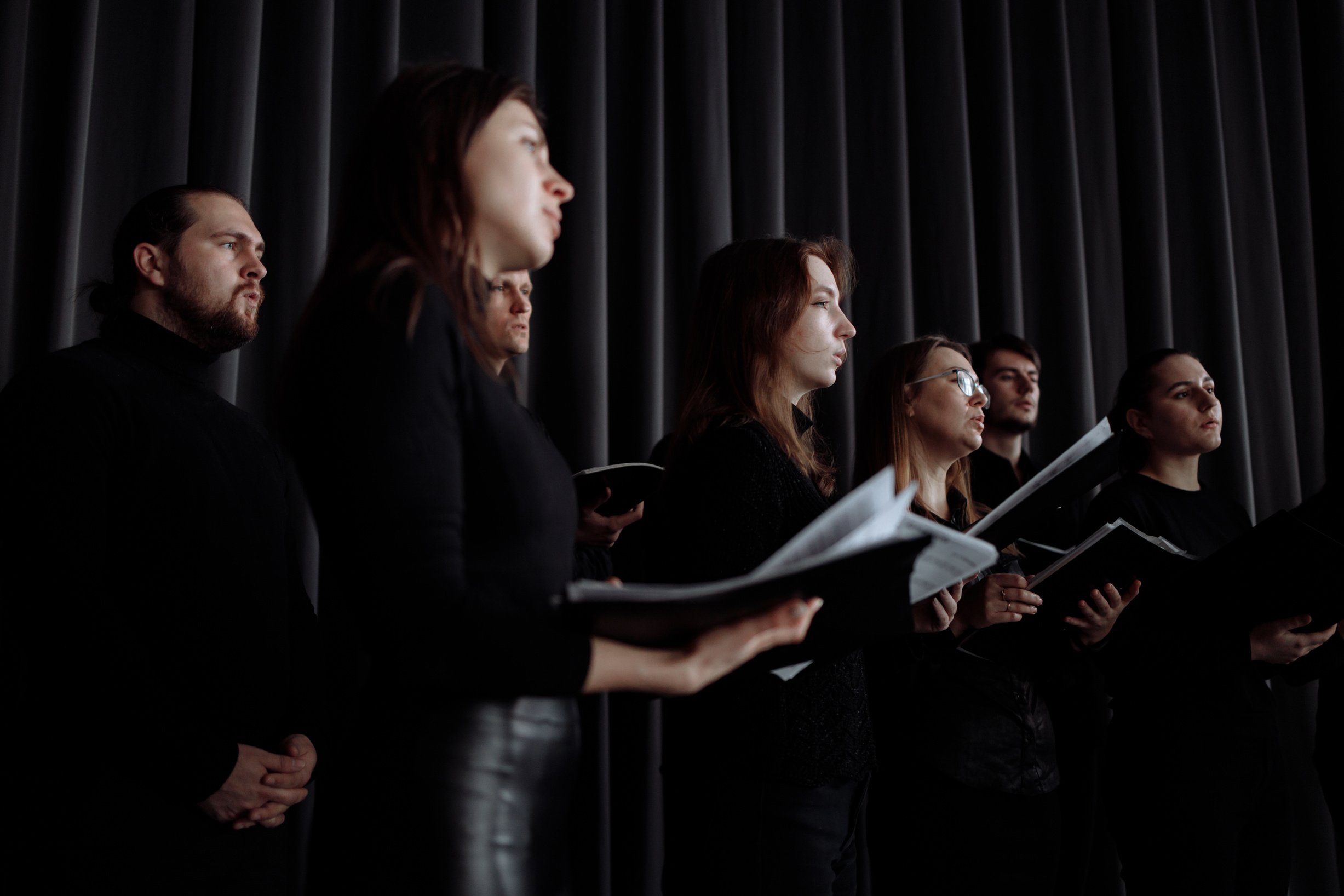 Group of Men and Women Singing Together